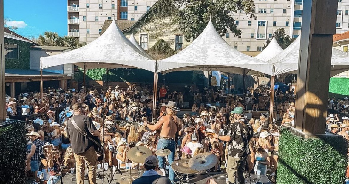 On-stage view of Shackelford Lane playing to a packed outdoor crowd under white tents